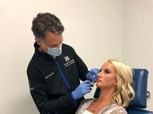 Dr. Bruno injecting lip filler