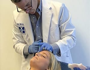 Dr. Brown doing botox on a patient 